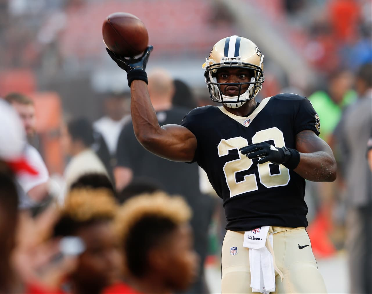 New Orleans Saints running back Adrian Peterson plays catch with some young fans before an NFL preseason football game against the Cleveland Browns, Thursday, Aug. 10, 2017, in Cleveland. (AP Photo/Ron Schwane)