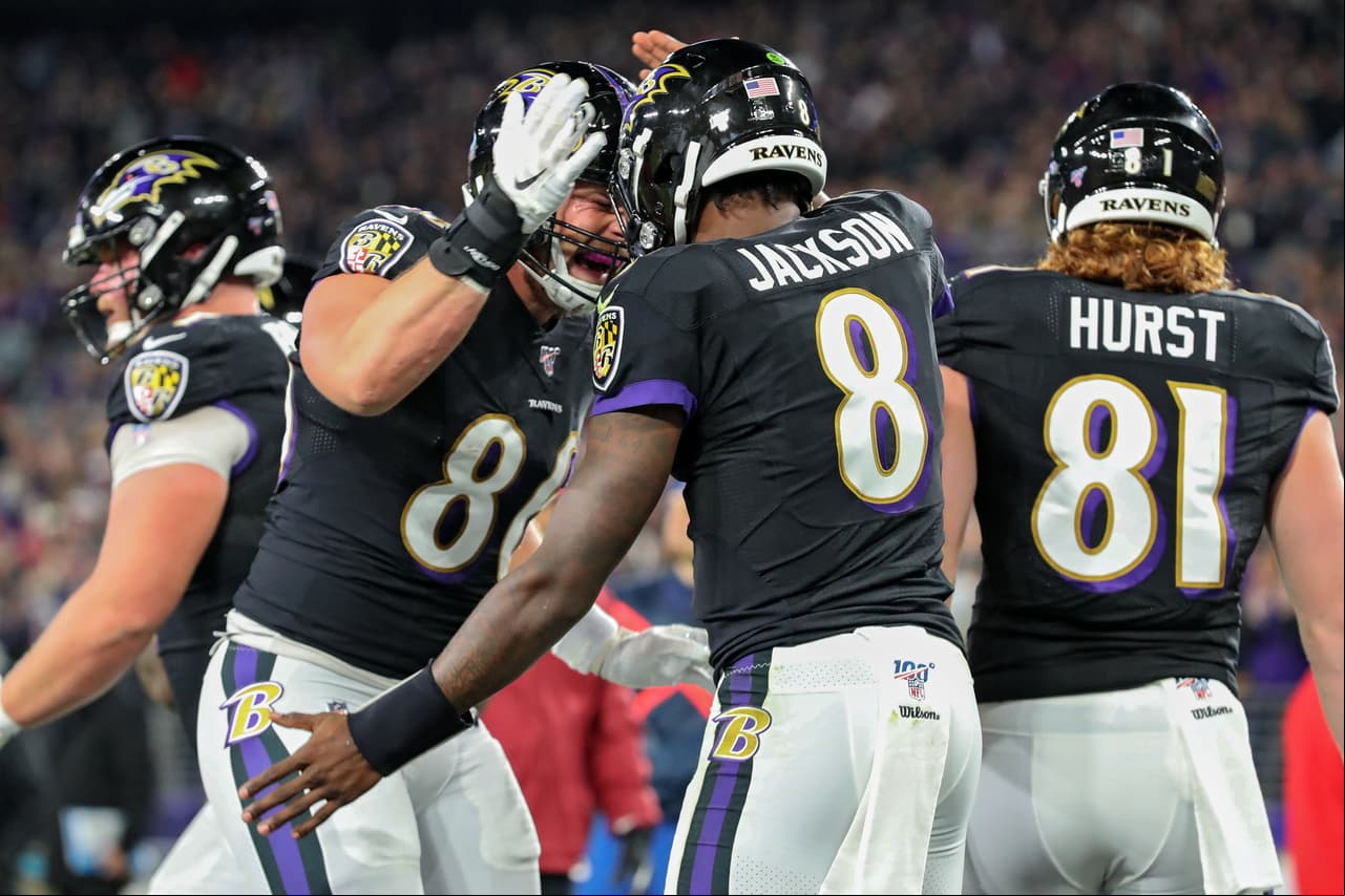 BALTIMORE, MARYLAND - NOVEMBER 03: Quarterback Lamar Jackson #8 of the Baltimore Ravens celebrates with teammates after scoring a first quarter touchdown against the New England Patriots at M&T Bank Stadium on November 3, 2019 in Baltimore, Maryland. (Photo by Todd Olszewski/Getty Images)